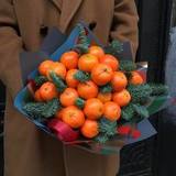 Photo of Bouquet of tangerines and fir branches 
