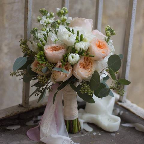 Romantic bouquet of the bride with white Ranunculus, elegant rose Juliet and fragrant Matthiola