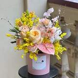 Photo of Colorful composition in a box with ranunculus and peony roses «Sunny Cupid»