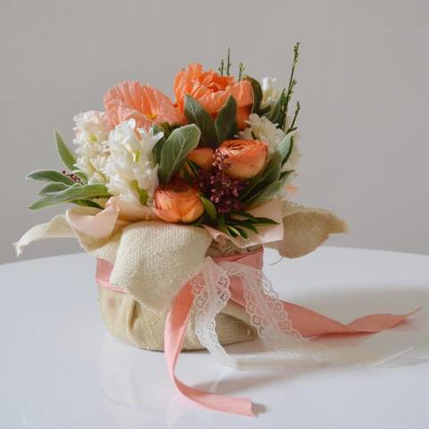 Composition with salmon Papaverums, Ranunculus and white Hyacinths