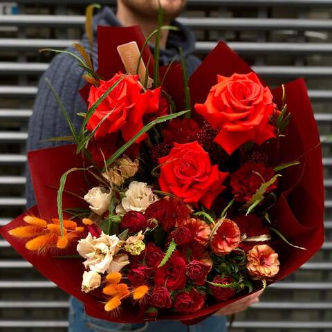 Bright bouquet with red roses, interesting ranunculus and eustoma «Fiery fox», Flowers: Pion-shaped rose, Bush Rose, Ranunculus, Dianthus, Grevillea, Lagurus, Eustoma, Skimmia
