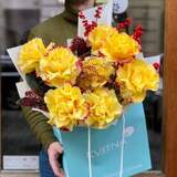 Photo of Bright bouquet of yellow roses, ilex and skimmia «Shining Marichka»