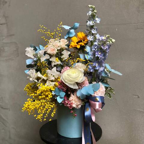 Light joyful composition in a box «Solar Glare», Flowers: Chamelaucium, Helianthus, Bush Rose, Genista, Dianthus, Oxypetalum, Pittosporum, Eucalyptus, Ranunculus, Lathyrus, Delphinium, Hyacinthus, Mimosa