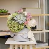 Photo of Interior composition from autumn hydrangeas, fragrant roses O'Hara and magic succulent