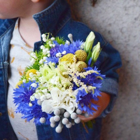 Children's bouquet with cornflowers, A small groom is waiting for his girlfriend with a cute baby bouquet with cornflowers