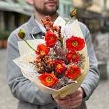 Photo of Bright orange bouquet of papaver and ilex with snow elements «Christmas light»