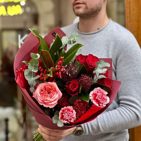 Red bouquet with roses, ilex and exotic leucospermum «Ardent look», Flowers: Dianthus, Ilex, Magnolia, Eucalyptus, Leucospermum, Skimmia, Rose, Pion-shaped rose