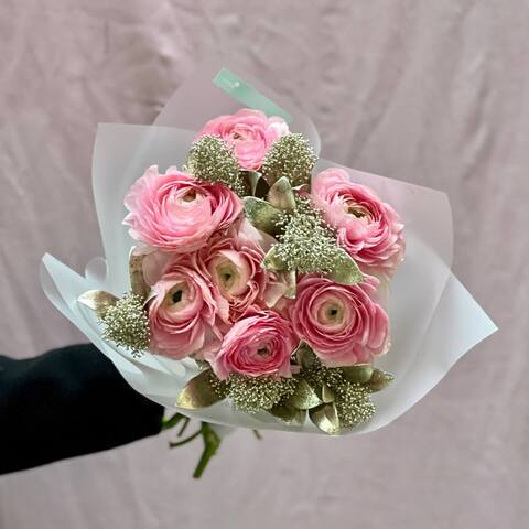 Photo of Delicate pink bouquet of 7 ranunculi and skimmia