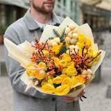 Photo of Sunny bouquet of yellow peony rosses, ilex and gossypium «Honey berries»