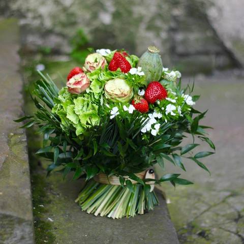 Summer floral sheaf with juicy strawberries and roses, Bouquet-sheaf in green grass hydrangea and strawberries
