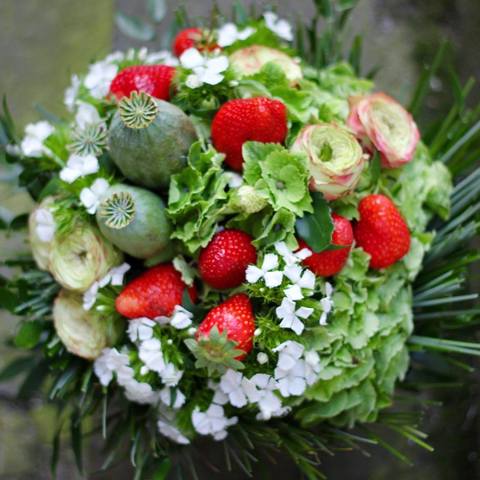 Photo of Summer floral sheaf with juicy strawberries and roses