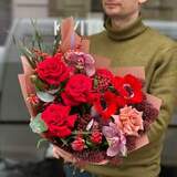 Photo of Luscious bouquet of red anemones and lacy skimmia with the addition of roses «Red handsome»