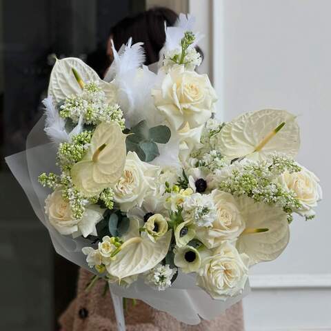 Bouquet in pure white colors with exotic anthurium and spring flowers «Wings of Love», Flowers: Hydrangea, Anemone, Freesia, Syringa, Anthurium, Rose, Matthiola, Eucalyptus, Feathers