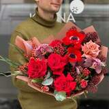 Photo of Luscious bouquet of red anemones and lacy skimmia with the addition of roses «Red handsome»