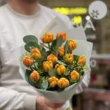 Photo of 15 orange tulips with eucalyptus in a bouquet «Fiery salsa»