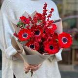 Photo of Bright bouquet of red anemones and ilex «Passionate kiss»