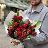 Photo of Red rich bouquet with tulips and skimmia «Christmas kiss»