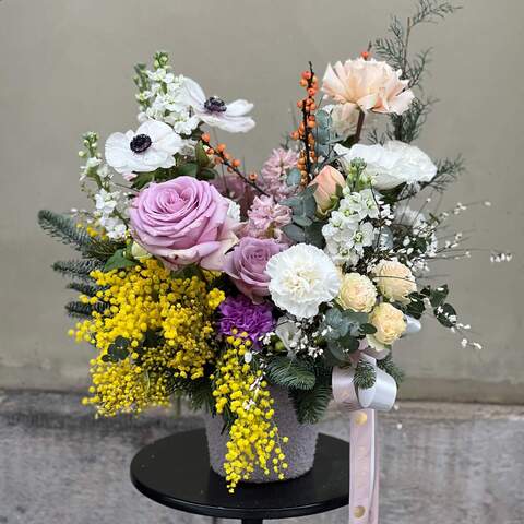 Picturesque composition in a fur planter «Spring Eve», Flowers: Mimosa, Nobilis, Rose, Helleborus, Anemone, Ranunculus, Hyacinthus, Dianthus, Eucalyptus, Matthiola, Ilex, Genista