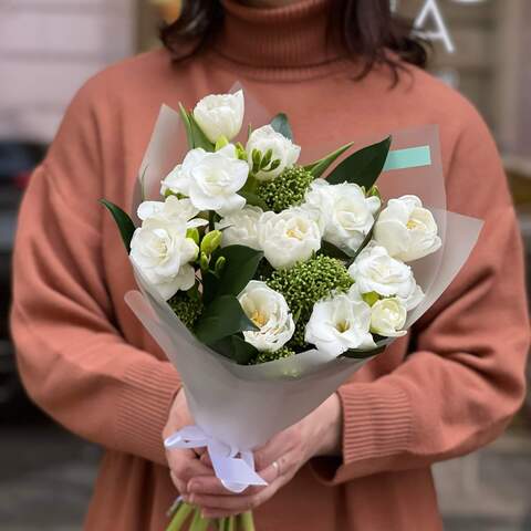 Photo of White and green delicate bouquet of tulips, fragrant freesias and skimmia «Cool pleasure»